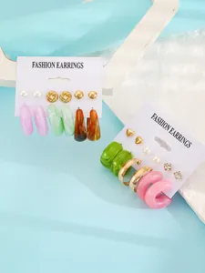 Detailed view of colorful resin hoop and stud earring sets on white display cards