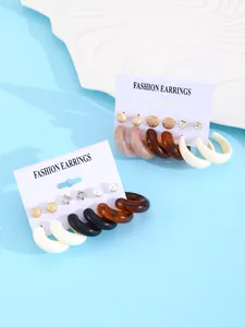Detail view of colorful 6-pair resin hoop and stud earring set on fashion display cards