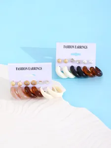 Detail view of 6-pair resin earring set featuring colorful studs and C-shaped hoops