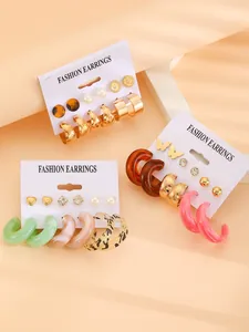 Close-up detail view of colorful resin hoop and stud earring sets on display cards