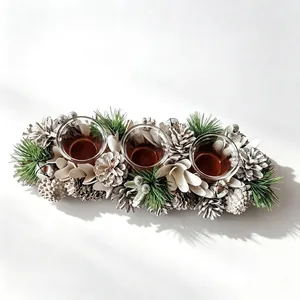 Close-up of a Nordic style Christmas pinecone candle holder with three glass cups.