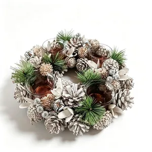 Close-up of a rustic Christmas wreath candle holder with pine cones and silver bells