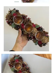 Hand-held Christmas wreath candle holder featuring natural pinecones and red roses