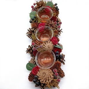 Festive Christmas candle holder garland with pinecones and red roses for table decor