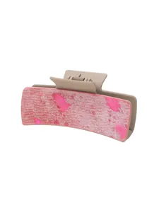 Détail d'une grande pince à cheveux avec une surface en similicuir texturé de couleur rose