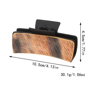 Large black matte shark clip with textured faux leather insert and dimension details