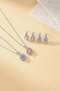 Detail view of pavé zircon jewelry set including necklaces and earrings in pink and white