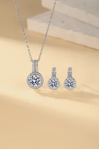 Detailed view of an elegant silver-toned jewelry set with halo-set zircon stones
