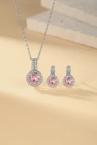 Close-up of pink zircon jewelry set with necklace and stud earrings in silver finish
