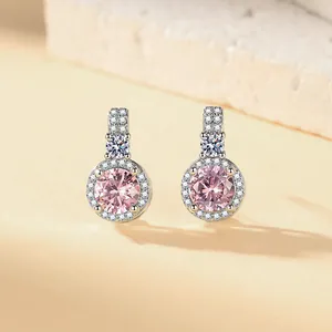 Macro view of elegant pink zircon stud earrings featuring a sparkling crystal halo
