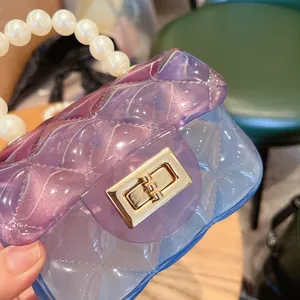 Macro di un'elegante borsa jelly trasparente sfumata viola e blu con un manico di perle
