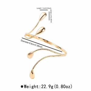 Gold multi-layer crossover arm cuff with teardrop accents and detailed size specs