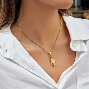 Elegant model wearing a golden seashell pendant necklace on a durable stainless steel chain.
