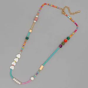 Detailed view of handmade beaded necklace with shell hearts and colorful gemstones