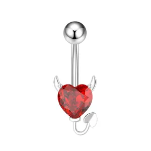 Close-up of silver-toned navel ring with red heart zircon and devil horn design elements