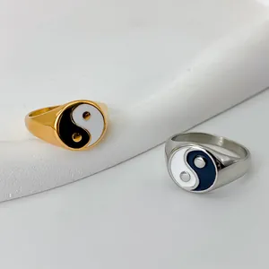 Gold and silver stainless steel Yin Yang rings with black and white enamel detail