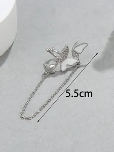 Macro detail of elegant silver butterfly ear cuff featuring a 5.5cm long tassel chain