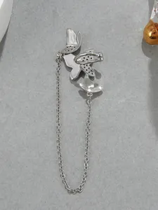 Detailed macro shot of silver butterfly ear cuff featuring a delicate long chain tassel