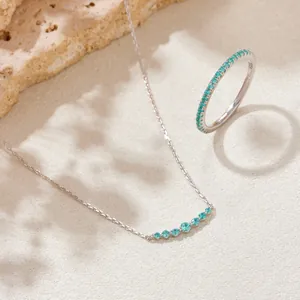 Elegant detail of S925 sterling silver necklace and matching cyan gemstone ring