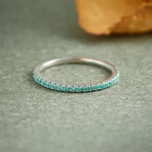 Close-up of S925 silver ring with small turquoise stones in an eternity row
