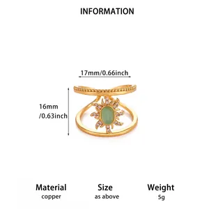 Detailed view of vintage 18K gold plated copper open ring with green stone and sun design