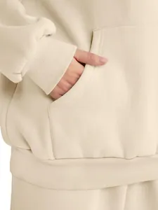 Close-up detail of pocket and ribbed cuff on beige women's casual fleece hoodie