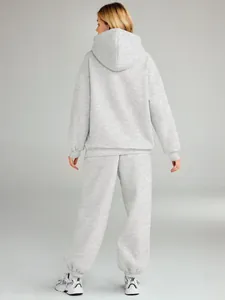Back view of women's grey two-piece tracksuit with oversized hoodie and pants
