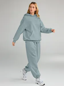Full body view of women's oversized tracksuit set showing the fit and light blue color