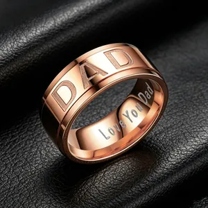Close-up of 8mm rose gold stainless steel ring with Dad engraving