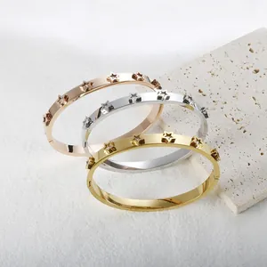 Set of three 18K gold plated star-motif titanium steel bangles with sparkling stones