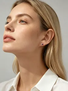 Gros plan d'une boucle d'oreille en argent s925 avec zircon rouge ovale sur modèle