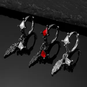 Gothic style hoop earrings with red zircon and silver feather charms on black background
