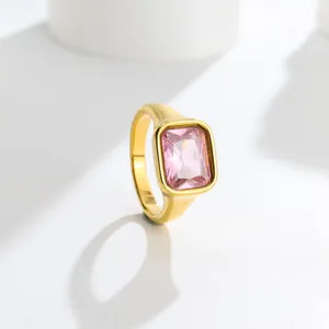 Close-up of an elegant gold titanium steel ring featuring a rectangular pink gemstone.