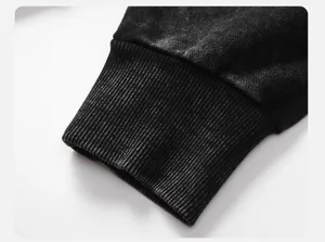 Close-up of ribbed cuff on vintage washed black hoodie showing premium 360G fabric texture