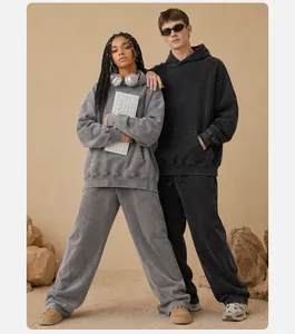 Detailed view of oversized vintage washed hoodies worn by models in a desert rock setting
