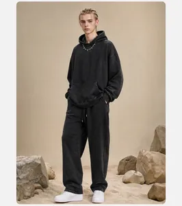 Model wearing professional vintage acid wash black oversized hoodie and sweatpants set