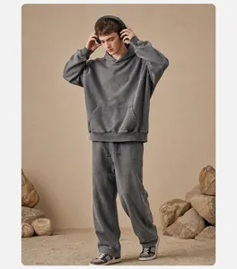 Full body view of vintage washed grey oversized hoodie and joggers set on earth tone background