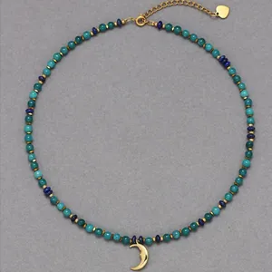Detalle de collar de cuentas de piedra natural con un colgante de luna creciente dorada