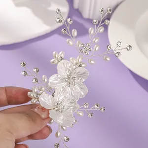 Épingle à cheveux de mariée élégante avec fleurs blanches, perles et strass pour mariages.