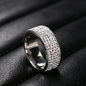 Detailed close-up of a titanium steel ring encrusted with five rows of sparkling crystals.