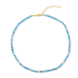 Detail view of blue faceted natural stone necklace with gold spacers and lobster clasp.