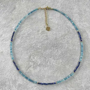 Top view showing detailed faceted blue natural stone beads and gold spacer necklace