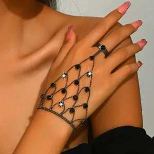 Close-up detail of a gothic black mesh hand chain with rhinestones on a model's hand