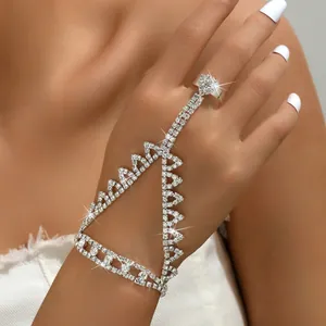 Close-up of sparkling rhinestone finger ring slave bracelet with geometric mesh design