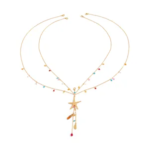 Gold body chain with starfish pendant, colorful beads and shell detail for beach wear.