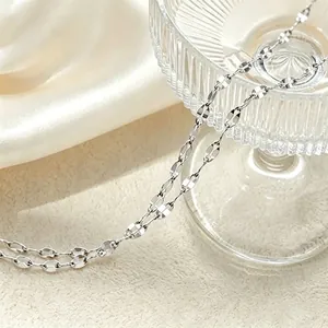 Close-up detail showing the metallic texture of the titanium steel lip chain necklace.
