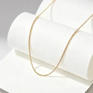 Detail view of minimalist gold titanium steel curb chain necklace for women.