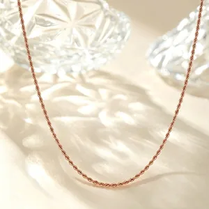 Detailed view of an elegant rose gold twisted rope chain necklace on a sparkling background