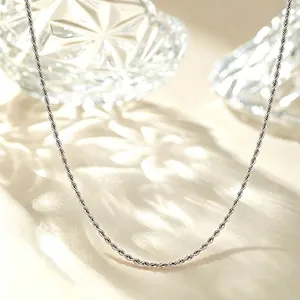 Close-up detail of a minimalist silver titanium steel rope chain necklace for daily wear.