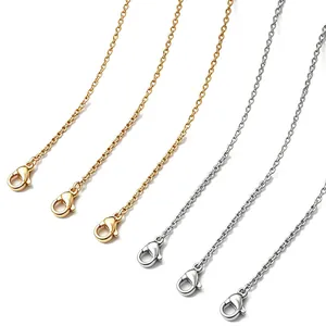 Detailed view of gold and silver titanium steel O-chains with secure lobster clasps.
